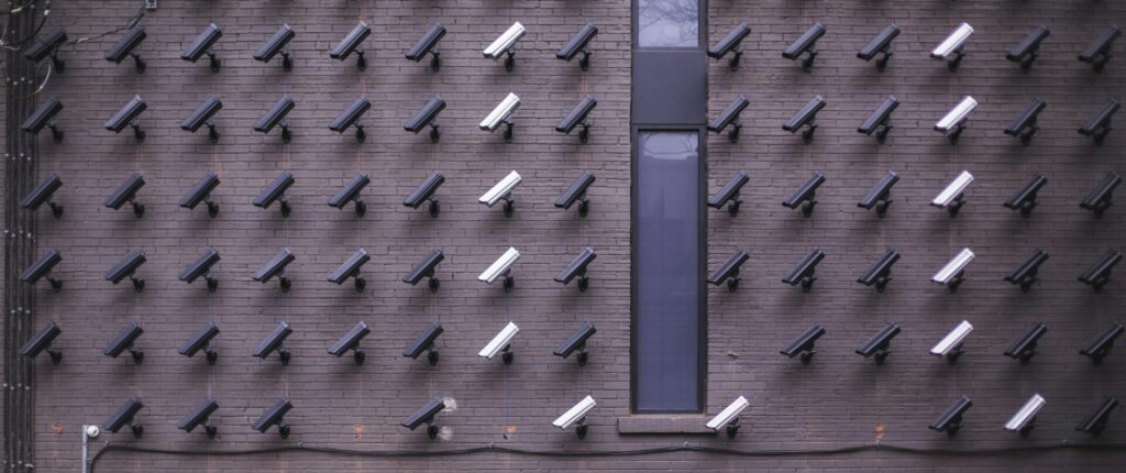 Many cameras on a wall, all connected to a CCTV system with an underlying architecture.